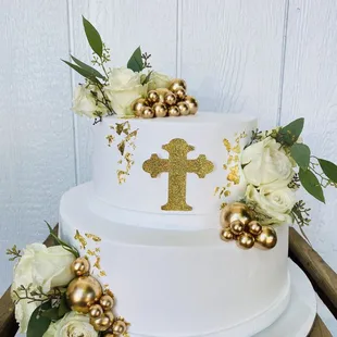 a white cake with gold decorations