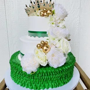 a cake decorated with flowers and a crown