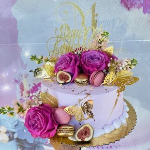 a cake decorated with figurines and flowers
