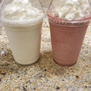 two cups of milkshakes on a counter