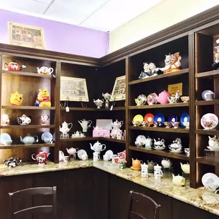 a collection of teapots and mugs