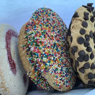 three doughnuts with sprinkles and chocolate chips