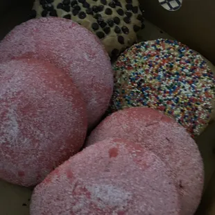 a box of doughnuts with sprinkles
