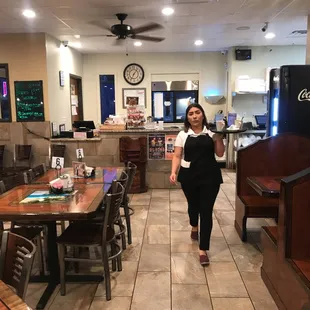 a woman walking through a restaurant