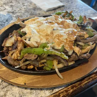 Chicken steak mix fajitas topped with Oaxaca cheese