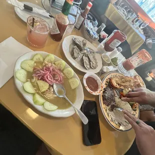 Oysters, chorizo con queso, aguachilles, steak and lobster. Watermelon margarita and michelada