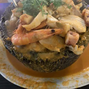 Molcajete - Mexican soup loaded with seafood served steamy hot in a molcajete.