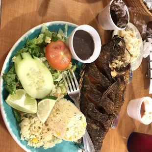 a plate of fish, rice and vegetables