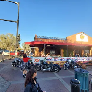 motorcycles parked in front of a restaurant