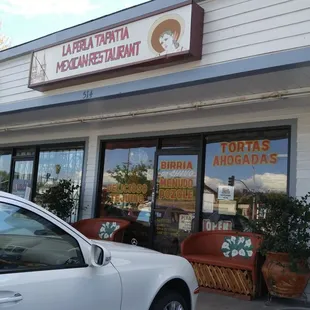 a car parked in front of a restaurant