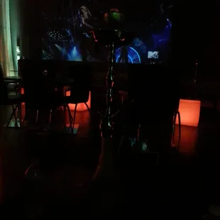 a table and chairs in a dimly lit room