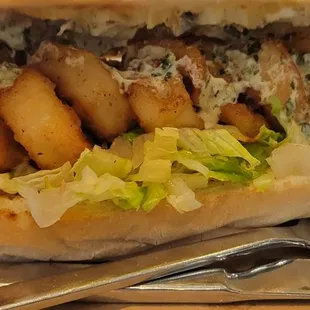 a hand holding a sandwich