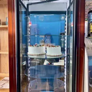 two cakes in a glass case