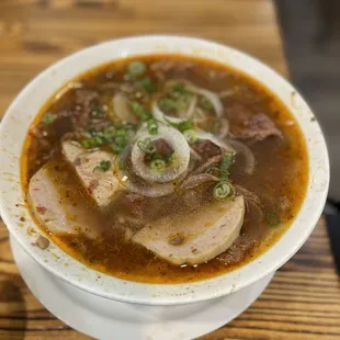 a bowl of soup on a wooden table