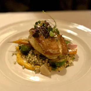 Pan seared flounder with couscous, brussel sprouts, root vegetables, and vinaigrette.