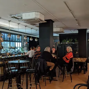 a group of people sitting at a bar