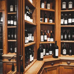 Bustling wine shop showcasing popular Cabernets, Chardonnays, Pinot Noirs, and sparkling varieties.