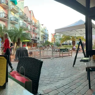 a view of a patio with tables and chairs