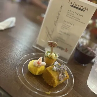 Seafood Leche de Tigre in cup, mini tamale, and potato topped with shrimp