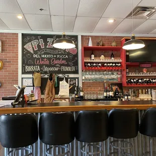 a bar with black stools