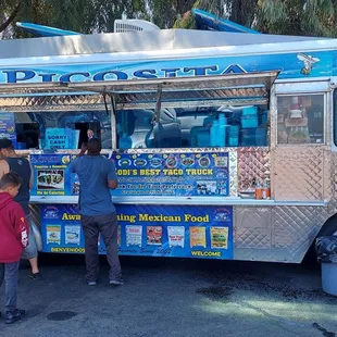 people ordering food from a food truck