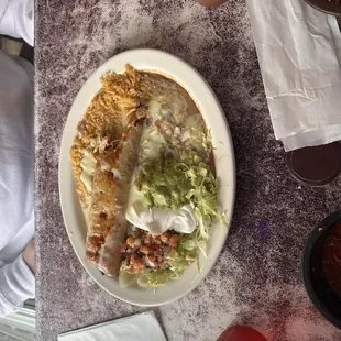 Chimichanga Grilled Chicken, with red rice, beans, salad. Pico De Gallo, and guacamole.