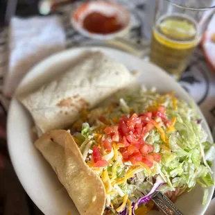 a plate of food and a glass of beer