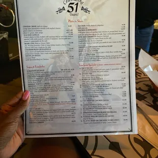 a person holding a menu