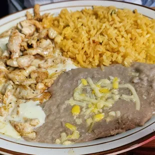 Chicken strips,cheese sauce, rice and beans