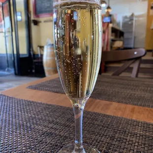 a glass of champagne on a table