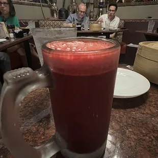a glass of juice on a table