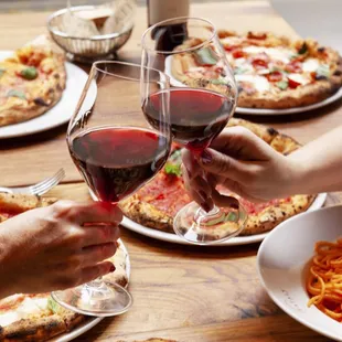 a group of people clinking glasses of wine