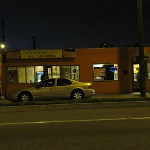 a car parked in front of a restaurant