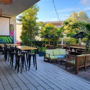 a patio with tables and chairs