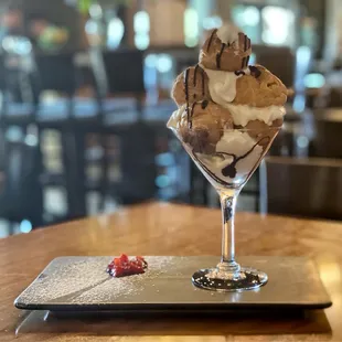 PROFITEROLES $9 Cream puffs filled with custard finished with chocolate sauce