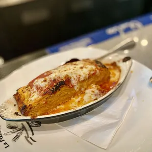 lasagna 25 layers of fresh lasagna noodles with bolognese sauce, béchamel sauce, parmesan; baked in oven with mozzarella