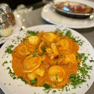 ravioli with lobster 37 creamy tomato sauce, prawns, and parsley