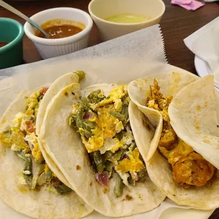 Two nopales and egg tacos, one chorizo and egg taco, and three salsas.  Flour tortillas.
