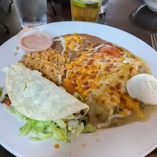 Combination meal with fish taco, cheese enchilada, and green tamales