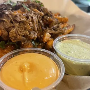 A cheese sauce and green sauce on the Side French Fries