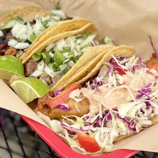 Three tacos. From front to back: Janitzio Fish, Lengua, and Diablo