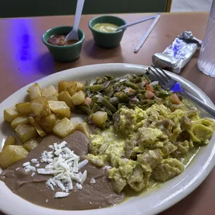 Chicharron and Egg with Nopales, beans, and potatoes.  Get the salsas on the side!