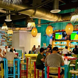 people sitting at colorful tables