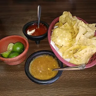 Homemade chips and red and green salsa