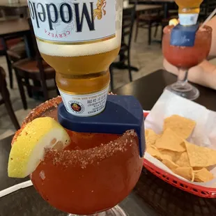 a glass of beer and a glass of chips