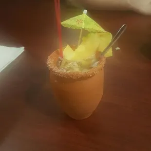 Cute hand made clay pot and filled to the brim with real chunks of pineapple and oranges!