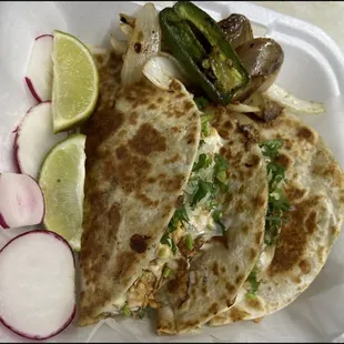 a plate of quesadillas with pickles