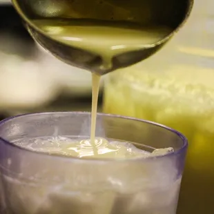 a pitcher pouring liquid into a glass
