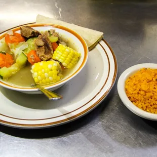 a bowl of soup and a plate of rice