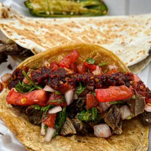 a plate of tacos with meat and vegetables